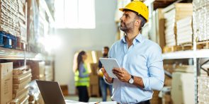 Manager using a digital tablet while working in a warehouse